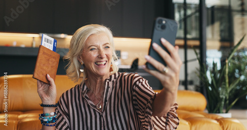 Canvas-taulu Mature, happy woman and passport with phone for selfie, travel memory or photography in home
