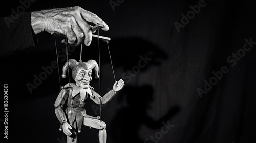 Hand controlling a marionette puppet on strings