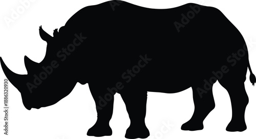 Majestic rhinoceros silhouette standing in profile isolated on white background, wildlife conservation icon and safari theme illustration for nature awareness and graphic design projects