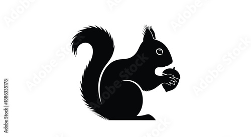 A striking silhouette of a squirrel holding a nut in its paws