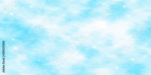 An abstract blue winter sky filled with bright fluffy clouds and soft bokeh sunlight creates a beautiful heaven-like nature view through the clear atmosphere