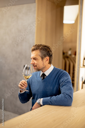 Man enjoys wine at a modern...