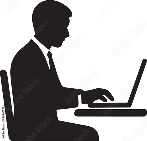 Silhouette of a businessman working on a laptop computer indoors
