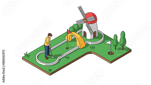 Young man playing miniature golf on a green course with a windmill obstacle, a yellow bridge, and trees under the bright sun.