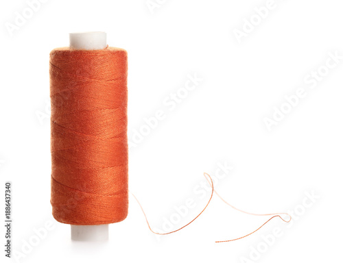Orange sewing thread on whi...