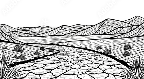 Dry cracked earth road leading through barren desert landscape with mountains.