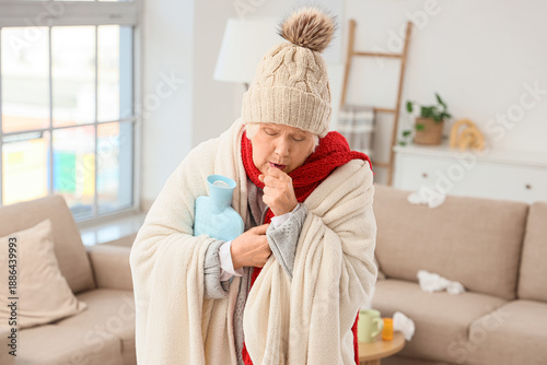 Sick elderly woman with hot...