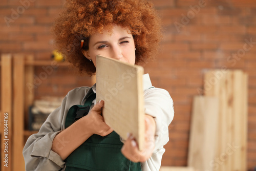 Young female carpenter with...
