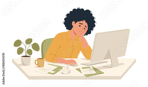 Woman frustrated at computer with crumpled paper
