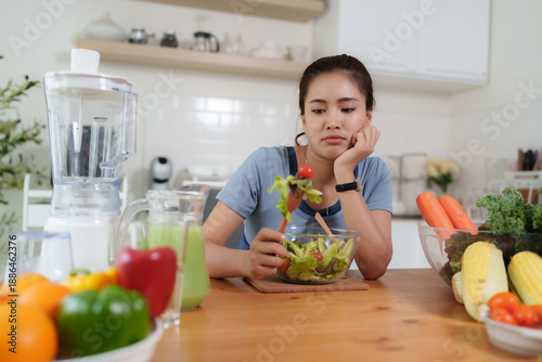Quadro em tela Woman feeling unhappy with diet meal in kitchen