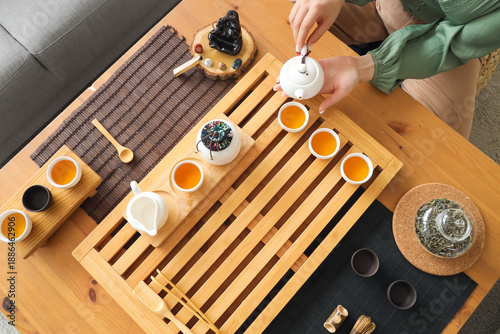 Woman pouring tea from whit...