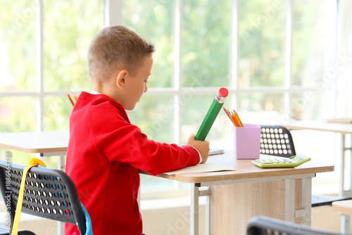 Cute little schoolboy with ...