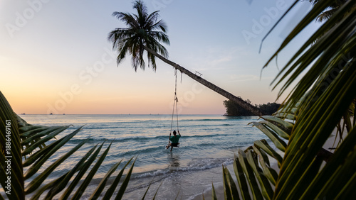 Canvas Print Experience the tranquil beauty of Khlong Hin Beach in Koh Kood, Thailand, where a lone swing hangs from a palm tree by the lapping waves at sunset, offering a perfect vacation escape