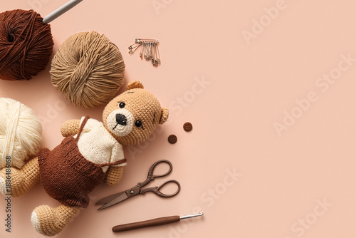 Knitted bear toy with yarn,...