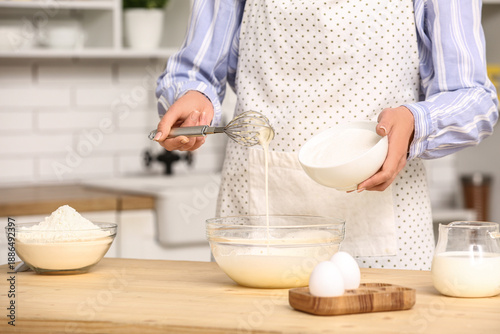 Woman putting sugar into bo...