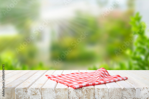 Canvas Print Red checkered fabric cloth placemat on white rustic wood table counter top and o