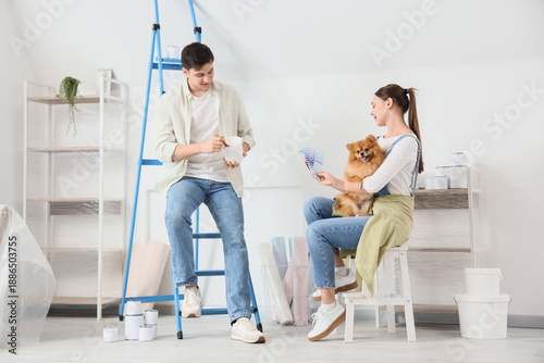 Young couple with paint and...