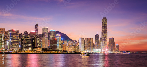 Canvas Print Hong Kong city skyline at sunset with glowing sky and skyscrapers