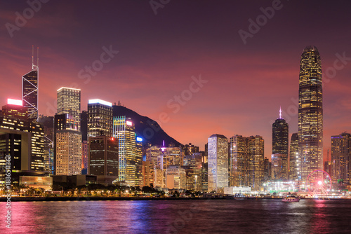 Canvas Print Hong Kong city skyline at sunset with glowing sky and skyscrapers