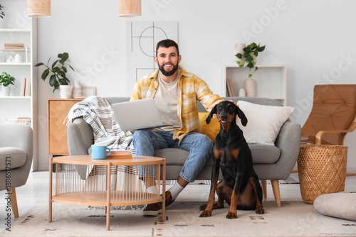 Young man with laptop and D...