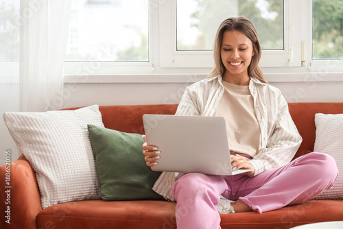 Young woman using laptop on...