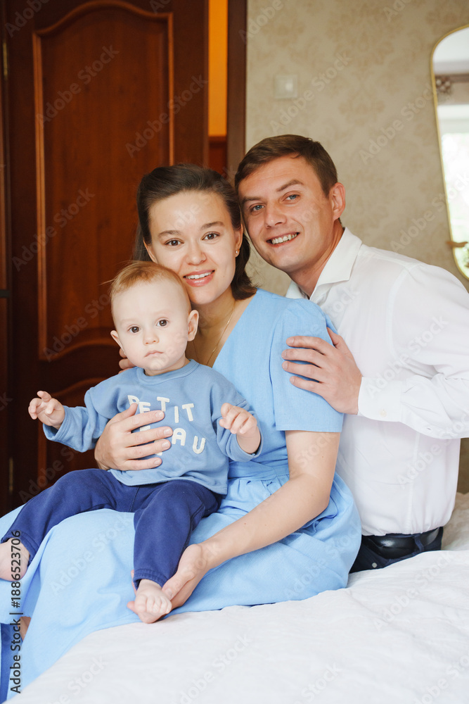 Fototapeta premium Family portrait in a cozy home setting with baby