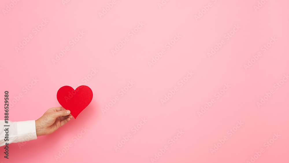 custom made wallpaper toronto digitalMan hand with paper heart figure on pink background. International Women's Day celebration