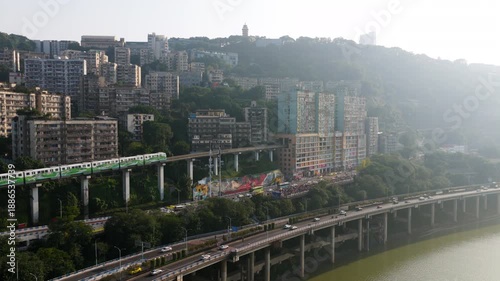 Monorail Train Coming Through A Residential Building At Liziba Station In Chongqing, China. - aerial shot