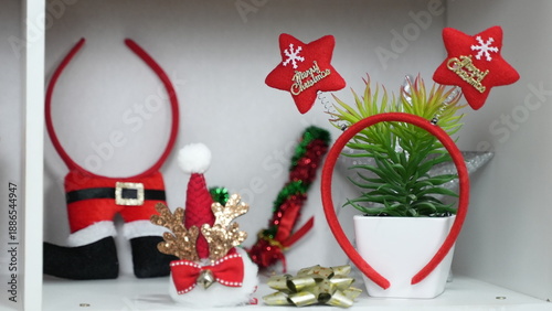 A festive Christmas gift and decoration set featuring red, green, and gold tones, arranged with a Christmas tree, decorative lights, and gift boxes. Creates a warm, cheerful atmosphere perfect for hol