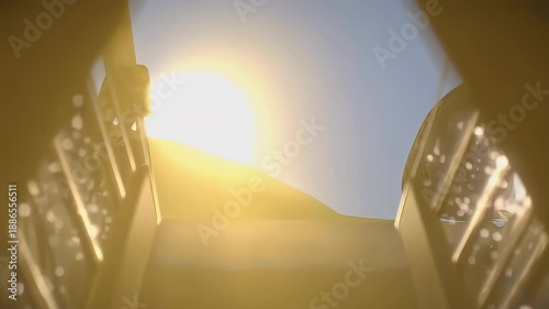 An illuminated hall focuses on a distant window, bathed in warm light