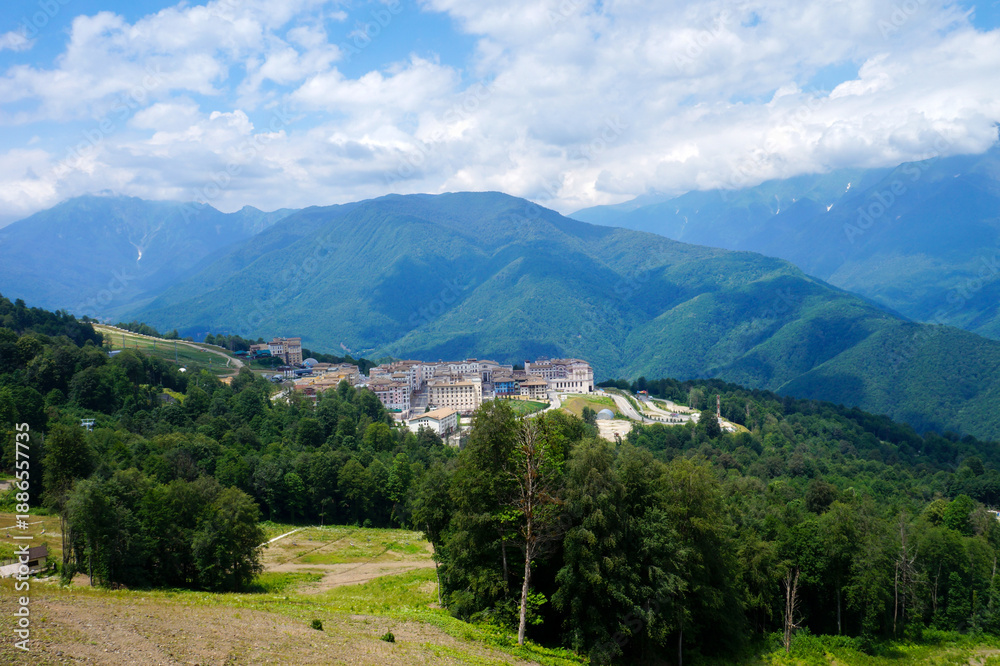 Obraz premium Mountain town nestled in green hills and forest