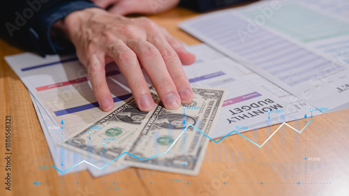 Hand showing dollar note with monthly budget planning, budget allocation for business or project management. Effective and smart budgeting