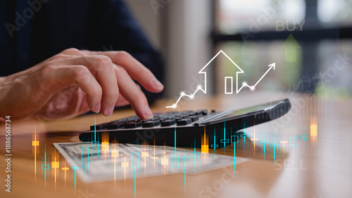 Businessman hand using calculator calculating prices and interests in Real estate investment marketing analysis, Concept of business prosperity and asset management