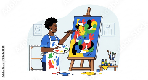 Artist painting colorful abstract art on canvas in studio with brushes and palette