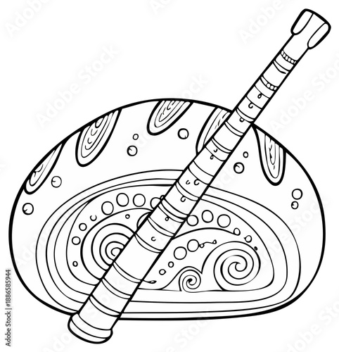 Stylized didgeridoo resting on a decorative, patterned object