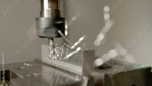 MACRO: Aluminium shavings come flying off a small workpiece during end milling.