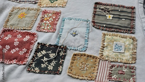 Assortment of small colorful fabric patches with detailed embroidery and stitching