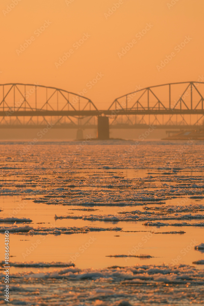 Obraz premium View of the road and railway bridges of the city of Torun at sunset