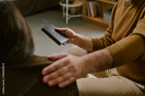 Tablou pe pânză Middle aged Caucasian man comforting by placing hand on shoulder while holding c