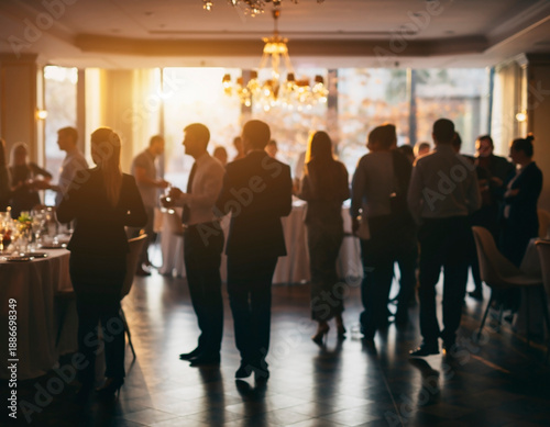Blurred corporate networking event with professionals socializing in a modern business environment. Abstract background ideal for concepts of communication, teamwork, business culture and professional