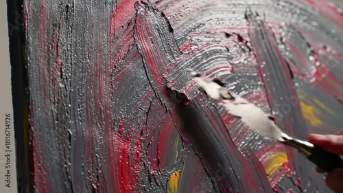 Abstract art creation close up of paint application with palette knife