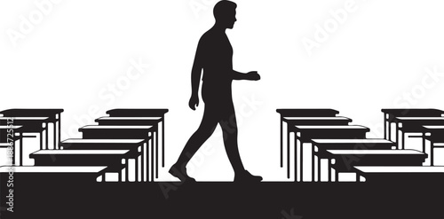 Silhouette of a person walking between rows of desks