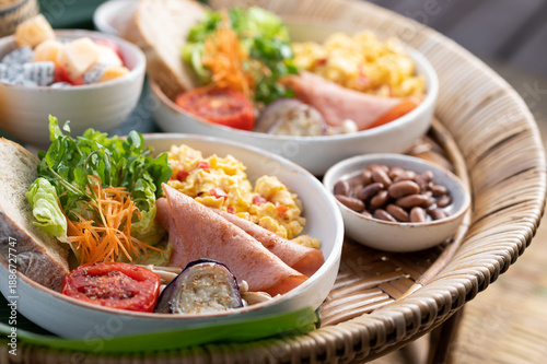 Healthy Breakfast Set on Bamboo Tray with Fresh Fruits and Pastries