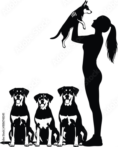 Silhouette of Woman Holding Puppy with Three Dogs Sitting Beside Her in Peaceful Scene of Pet Bonding and Companionship