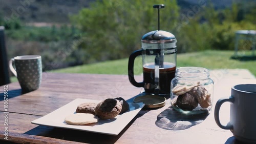 A serene coffee break setting with coffee and cookies on a wooden table  Cederberg, South Africa