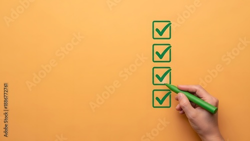 Hand using a green marker to check off boxes on a list against an orange background