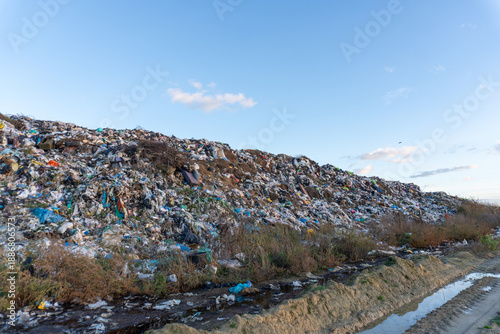 Bilde på lerret Trash mound near a waterway showing environmental issues and waste management co