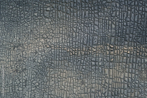 texture of an old wall with cracked bitumen coating