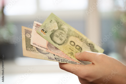 Canvas-taulu Woman s hand holding variety of international currency banknotes