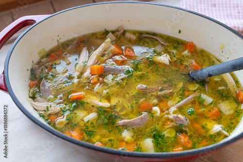 A pot with fresh cooked homemade chicken soup with noodles. German cuisine
